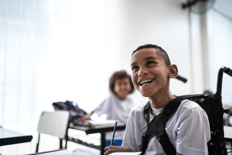 Happy wheelchair student studying in the classroom - stock photo
Happy wheelchair student studying in the classroom