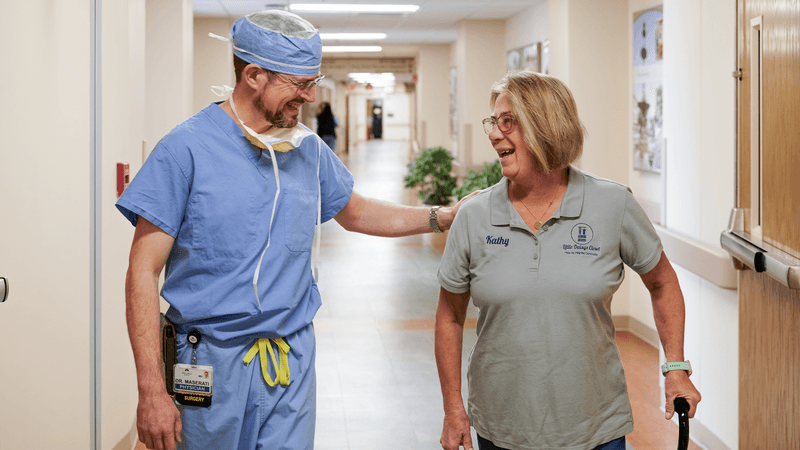 surgeon and patient in hallway