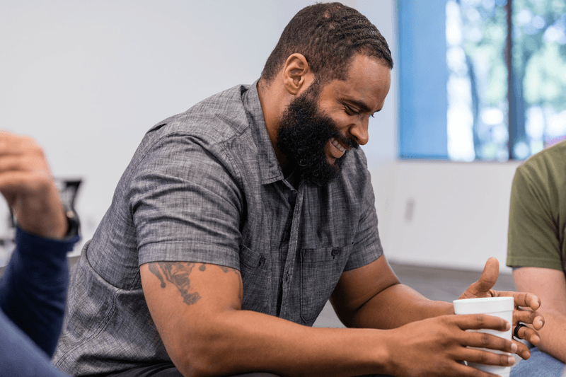 Focus on smiling mid adult man in group therapy - stock photo
The focus is on the smiling mid adult man in group therapy.