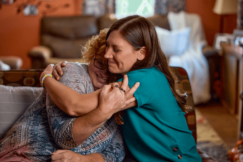 woman and nurse hug