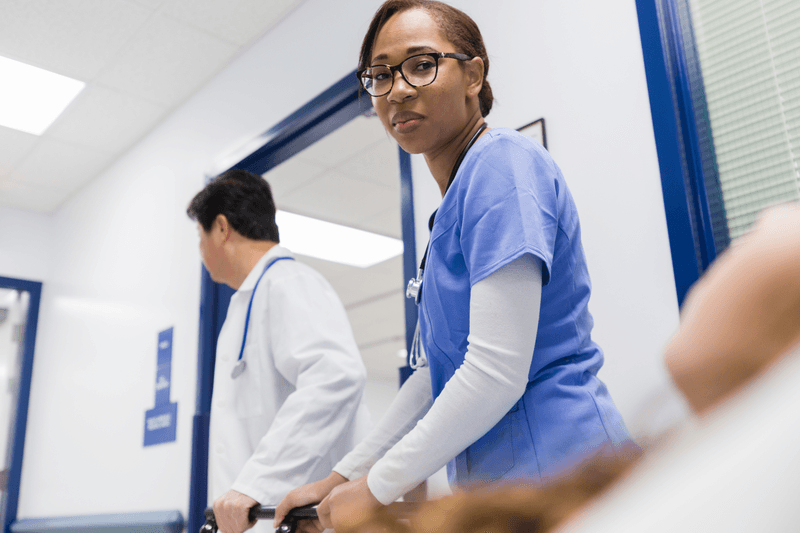 Seriously ill patient being taken into operating room - stock photo
Personal point of view photo of an unrecognizable patient looking up at a nurse while being taken into an operating room.