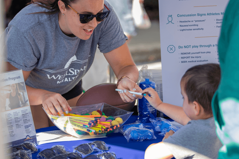 passing out goodies at community event